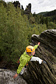 Female climber on Wegelagerer Felsen, Bielatal, Saxon Switzerland, Saxony, Germany