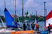 People on a jetty in front of the Ratzeburg cathedral, Ratzeburg, Schleswig Holstein, Germany, Europe