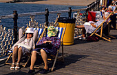 Europe, Great Britain, England, East Sussex, Brighton, Brighton Pier, women sunbathing