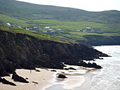 Hiker walking the Dingle Way on Slea Head beach, Near Dunquin, Dingle Peninsula, County Kerry, Ireland