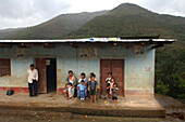 Family in front of their house in the mountains around Zomba, Ecuador, South America