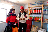 Indigenous local couple in a store on the Island of Taquille, lake Titicaca, Peru, South America