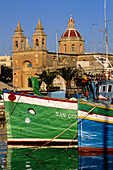 Luzzu boats anchored in Marsaxlokk harbour, Malta