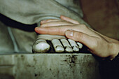 Close-up of a pilgrim hand on St Peter statue foot. Rome. Italy