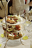 Triple tiered display of elegant snacks.