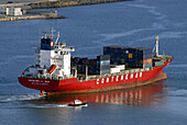 Pilot boat and merchant ship. Barcelona harbor. Catalonia. Spain.