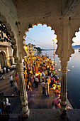 Making offerings 'puja' to the lake Pichola during a holy day, Gangaur Ghat. Udaipur. Rajasthan. India