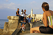 El Malecon on the background the Castillo de los Tres Reyes del Morro. La Havana. Cuba