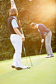 Two men playing golf, Strasslach-Dingharting, Bavaria, Germany