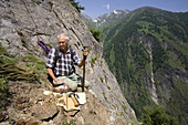 Rockhounder holding crystals, Baldschieder Valley, Bernese Alps, Canton of Valais, Switzerland