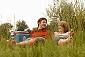 Young couple lying on blanket at lakeshore, Freising, Bavaria, Germany