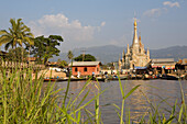 Fishing boats in front of the metallized Pagoda at the Nan Chaung Canal in Nyaungshwe, Inle Lake, Shan State, Myanmar, Burma
