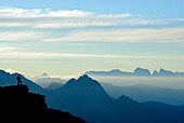 silhouette of hiker in front of Iffinger Spitze and Dolomites with Peitlerkofel, Piz Boe, Langkofel, Fünffingerspitze and Plattkofel, Spronser Joch, Texelgruppe range, Ötztal range, South Tyrol, Italy