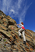 young woman on fixed rope route to Lazinser Rötelspitze, Spronser Seenplatte, Texelgruppe range, Ötztal range, South Tyrol, Italy
