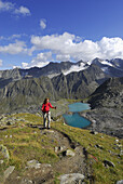 Woman hiking to Rinnenspitze, Stubai Alps, Stubai, Tyrol, Austria