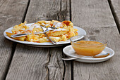 one portion of cut-up and sugared pancake with apple sauce on wooden table, alpine hut Sulzenaualm, Sulzaualm, Stubaier Alpen range, Stubai, Tyrol, Austria