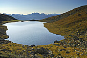 Lake Radl with Dolomites in background, Sarntal Alps, South Tyrol, Italy