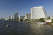 View of the Chao Phraya River and the  Shangri-La Hotel on the  River Bank and Boats on the River, Bangkok. Thailand