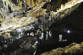 Tourists at Algar do Carvao cave, serra do Moriano, Terceira Island, Azores, Portugal