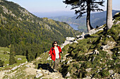 Woman hiking on the Brecherspitz over Schliersee, Bavaria, Germany