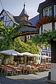 Guests sitting in a wine bar, Winningen, Moselle, Rhineland-Palatinate, Germany