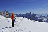 Woman hiking across Zugspitzplatt, Wetterstein range, Upper Bavaria, Bavaria, Germany