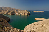 Deserted rocky coast under blue sky, Oman, Asia