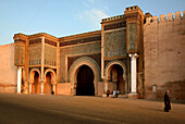 Locals in front of the town gate Bab el Mansour in the evening sun, Meknes, Morocco, Africa