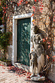 Sculpture in front of a house and vines, Torcello, Veneto, Italy
