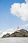 Mountain hut in a mountain landscape, Swiss Flag, St. Gotthard, Switzerland