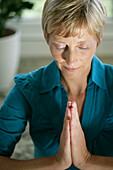 Mature woman meditating, Styria, Austria