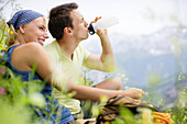 Young couple having a picnic, Werdenfelser Land, Bavaria, Germany