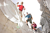 Hikers on cornice, Werdenfelser Land, Bavaria, Germany