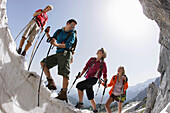 Hikers on cornice, Werdenfelser Land, Bavaria, Germany