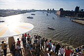 Passengers on cruise ship AidaDiva looking at harbour and Elbe river, Hamburg, Germany