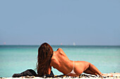 Woman sunbathing at the beach, South Beach, Miami Beach, Florida, USA