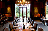 A long table is laid at the deserted dining room of the Treetops Lodge, North Island, New Zealand, Oceania