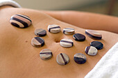 Spa treatment, warm stones lying on the nude belly, Kangaroo Island, South Australia, Australia