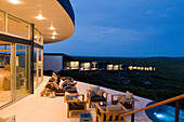 People on the illuminated terrace in front of the rooms of Southern Ocean Lodge, Kangaroo Island, South Australia, Australia