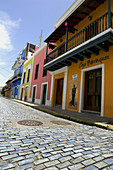 Old Cobblestones streets still exists in parts of Old San Juan like this Calle San Sebastian, San Juan, Puerto Rico, Caribbean Sea.