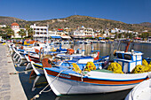 Colorful fishing boats in the harbour of the seaside village of Elounda, Crete, Greece.