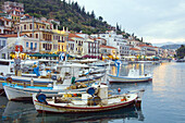Pastel colored buildings on the waterfront and colorful fishing boats at the attractive fishing town of Githeo, Greece.