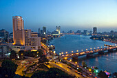 The 6th of October bridge over the Nile River and the Semiramis Intercontinental Hotel at dusk in Cairo, Egypt