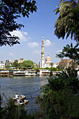 Two rowboats in the Nile River with a mosque in Cairo, Egypt