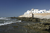 View of the impressive portugese fortification of Essaouira with the surf of the Atlantic Ocean and the white washed buildings and blue doors and window frames - typical for a former judish settlement, Morocco, Maghreb, North Africa