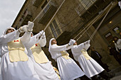 Men dressed in traditional costumes and carrying a Christ coffin during the Easter processions. Enna. Sicily. Italy