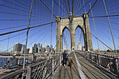 Woman jogging with dog, Brooklyn Bridge, Manhattan, New York City, New York, USA