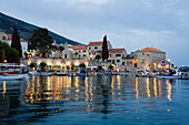 Illuminated houses at Bol harbour in the evening, Brac Island, Dalmatia, Croatia, Europe