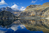 Reflection of mountains on lake Bacino del Truzzo, Oberhalbstein Alps, Chiavenna, Sondrio, Lombardy, Italy