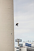 Two industrial climbers abseiling on the tower of Berlin's Television Tower, Alex, Berlin, Germany